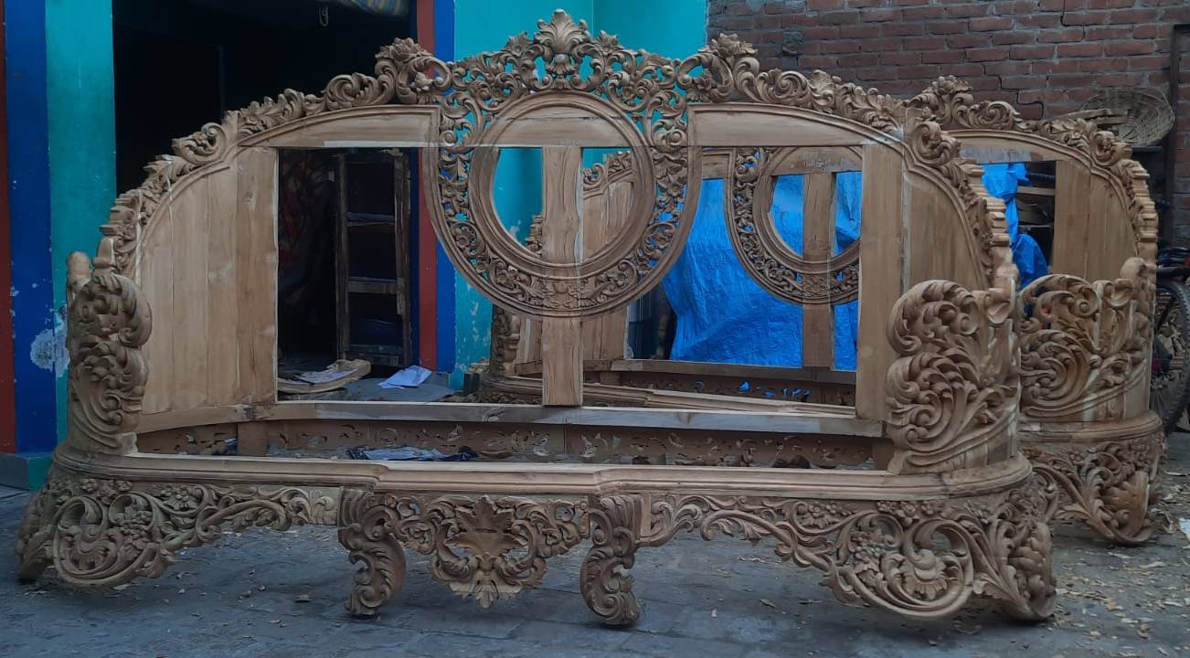 Luxurious handcrafted wooden sofa frame with intricate carvings showcased in Saharanpur, designed for elegance and comfort.