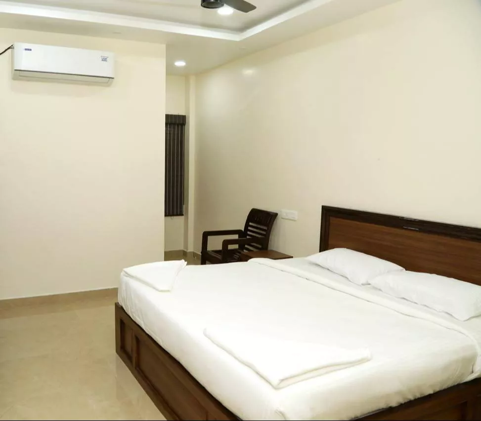 Cozy and well-furnished AC Double Room for 2 guests at Sudha Grand in Chennai, featuring comfortable beds and modern decor.