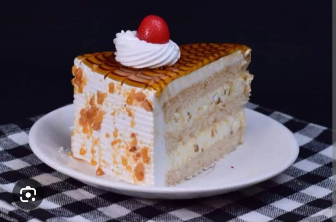Delicious creamy butterscotch pastry slice filled with caramel, showcasing a golden-brown top and rich textures, from NUNAVAT
