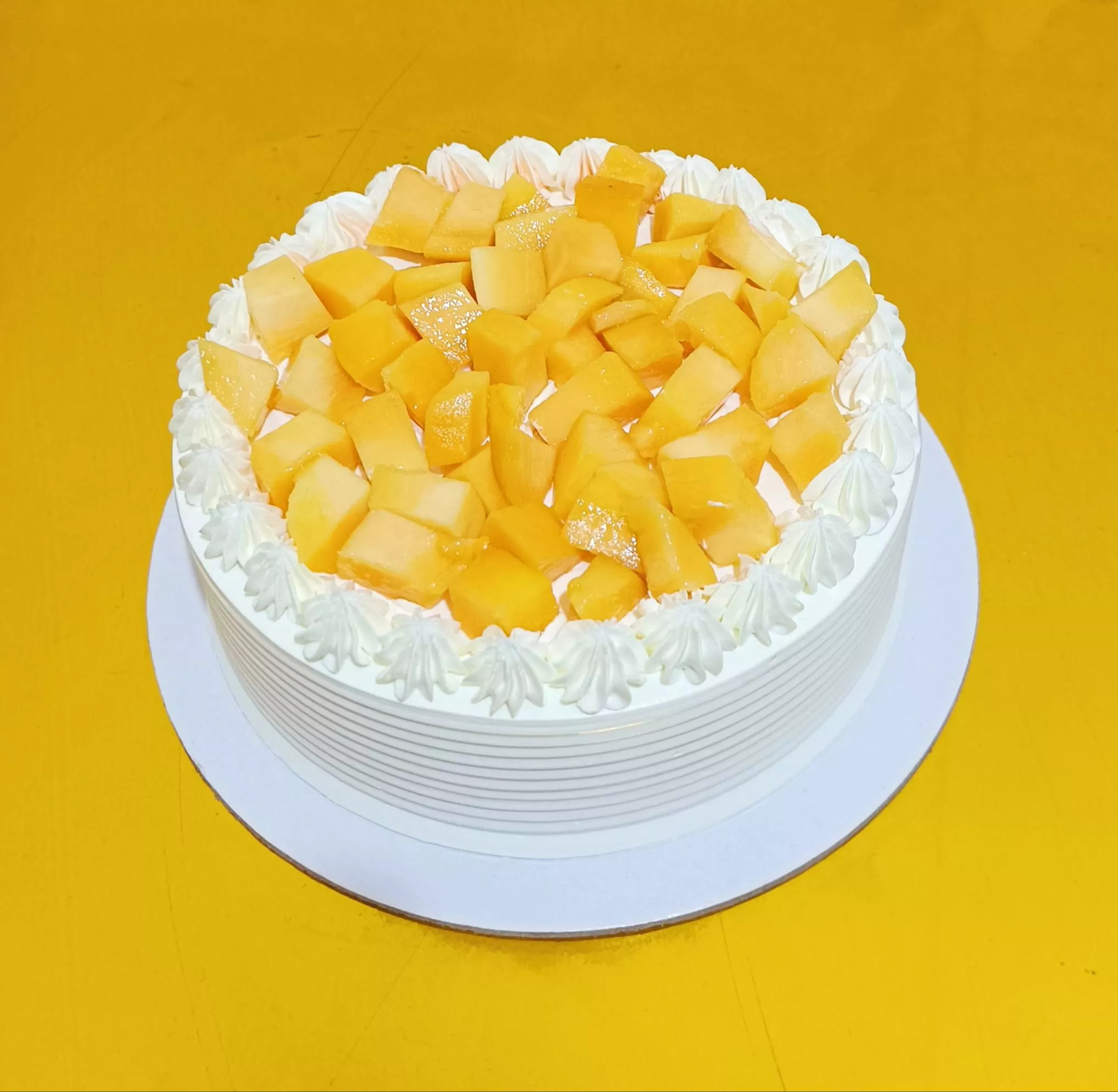Mango Delight Cake in Bangalore featuring a creamy texture and vibrant mango topping, ideal for celebrations and dessert love