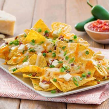 Crispy Cheesy Nachos Platter topped with jalapeños in Kolkata