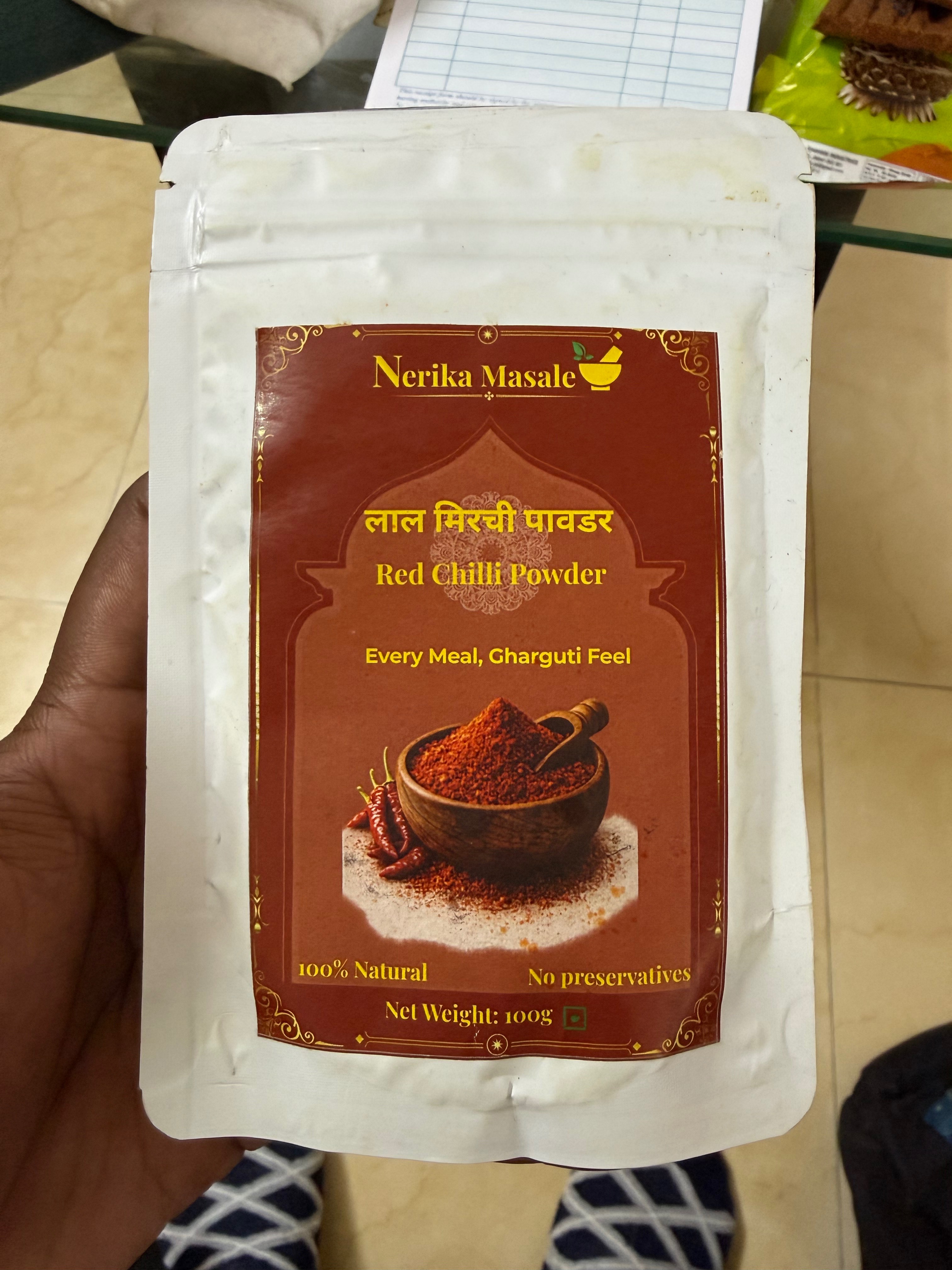 Vibrant red chilli powder packed in a container, showcasing the product from NERIKA MASALE in AHILYANAGAR.