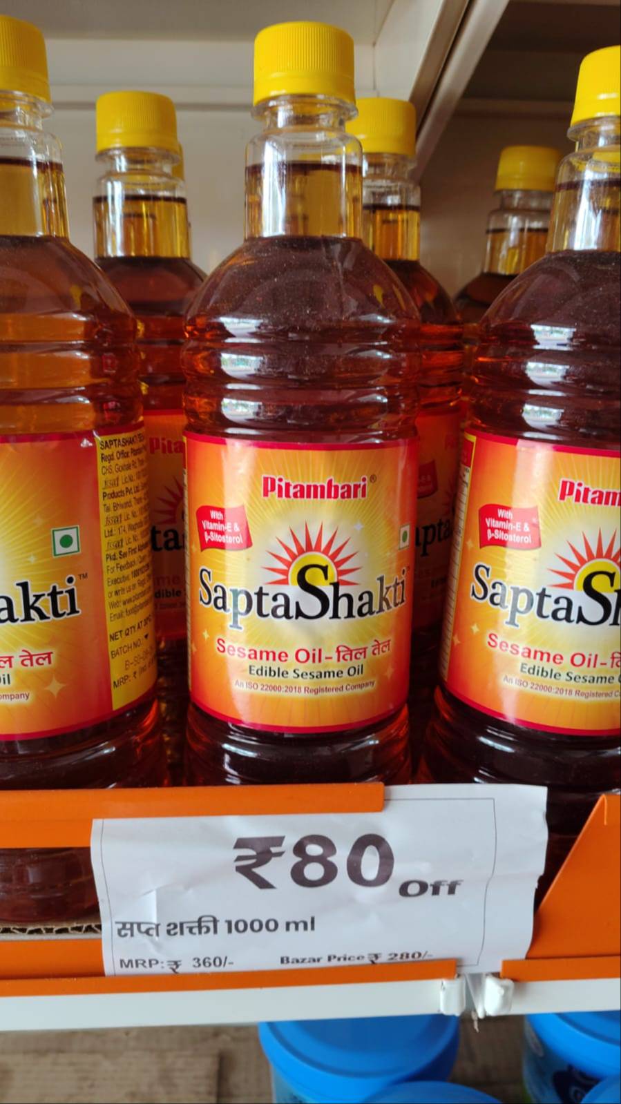 Bottle of Saptshakti Sesame Oil on a wooden table in Malwan