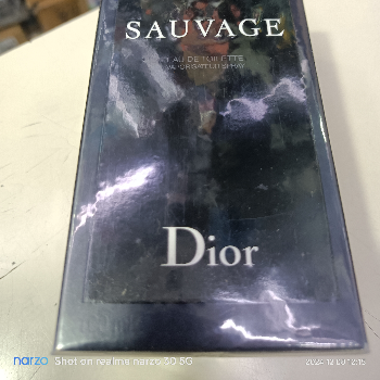 Dior Sauvage Fresh Spicy Signature Perfume bottle showcasing a sleek design with a dark blue hue, labeled prominently, set ag
